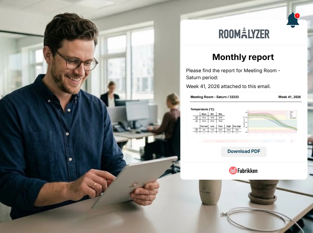 A person in an office reading a monthly report on a tablet.